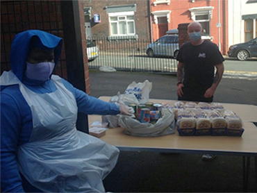 A Sister serving food to the homeless